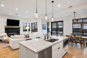 Kitchen featuring appliances with stainless steel finishes, light wood-type flooring, visible vents, and a sink