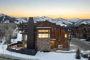 View of front of house with a chimney and a mountain view