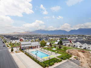 Pool with a mountain view, fence, and a residential view