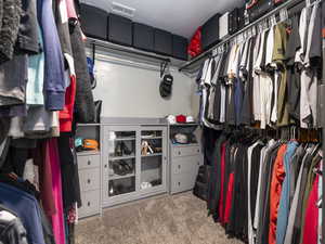 Walk in closet featuring visible vents and carpet flooring