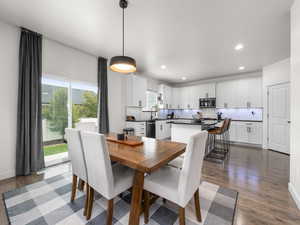 Dining space with recessed lighting, a wealth of natural light, and wood finished floors