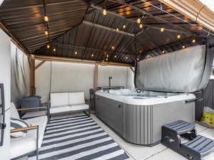 View of patio / terrace with an outdoor hangout area, a gazebo, and a hot tub