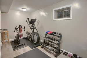 Exercise room featuring light hardwood / wood-style floors