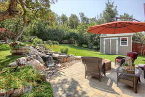 View of patio / terrace with a shed