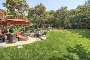 View of yard featuring a patio area and a fire pit