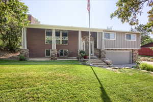 Raised ranch with a garage and a front lawn