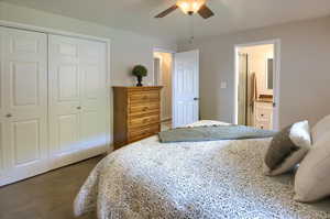 Bedroom with a closet, carpet floors, connected bathroom, and ceiling fan