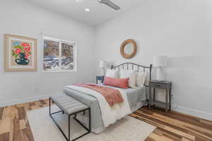 Bedroom with a ceiling fan, recessed lighting, baseboards, and wood finished floors