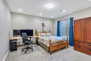 Bedroom with light carpet, baseboards, visible vents, and recessed lighting