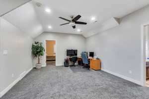 Office area/loft featuring lofted ceiling, carpet, visible vents, and baseboards