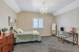 Bedroom with carpet flooring, vaulted ceiling, visible vents, and baseboards