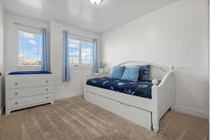 Bedroom with carpet flooring and baseboards