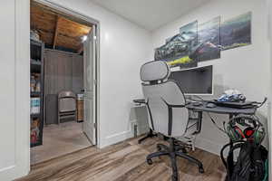 Office space with baseboards and wood finished floors