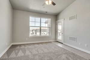 Unfurnished room with carpet and visible vents