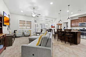 Living room with ceiling fan, light tile patterned flooring, visible vents, and recessed lighting