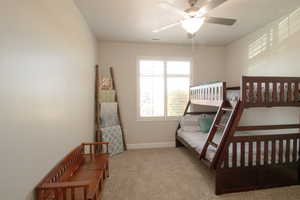 Bedroom with carpet, baseboards, and a ceiling fan