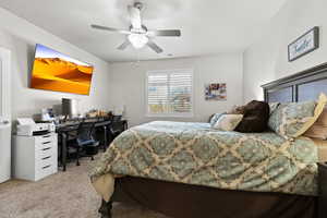 Bedroom featuring a ceiling fan, visible vents, and carpet flooring