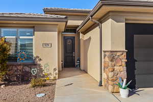 Property entrance with a tiled roof and stucco siding