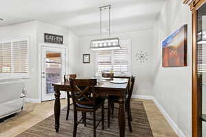 Dining space featuring light tile patterned flooring, visible vents, and baseboards