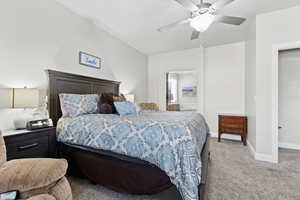 Bedroom with carpet, ceiling fan, and baseboards