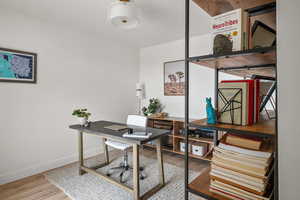 Home office featuring baseboards and wood finished floors