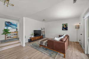 Living room with light wood-style floors and baseboards