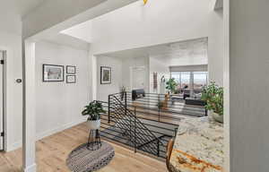 Entryway with baseboards and wood finished floors