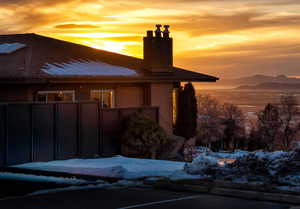 Exterior space with a chimney, a mountain view, and brick siding