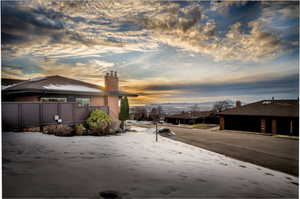 Exterior space featuring a chimney and brick siding