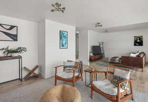 Living area with baseboards and wood finished floors