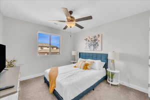 Bedroom with carpet floors, baseboards, visible vents, and ceiling fan