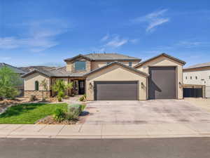 View of front of house with driveway, stone siding, an attached garage, fence, and stucco siding