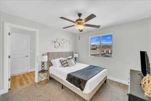 Bedroom featuring a ceiling fan, baseboards, and carpet flooring