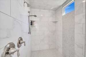 Bathroom featuring tiled shower