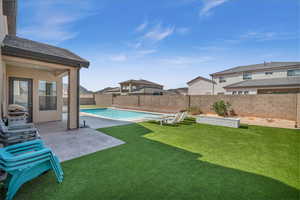 View of yard with a fenced in pool, a patio area, and a fenced backyard