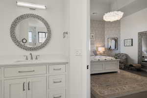 Ensuite bathroom featuring ensuite bath, visible vents, wood finished floors, and vanity