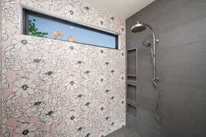 Full bath featuring a tile shower