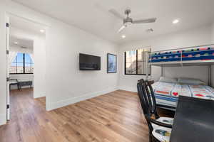 Bedroom with multiple windows, visible vents, wood finished floors, and recessed lighting