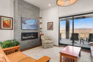 Living area featuring a fireplace, wood finished floors, and recessed lighting