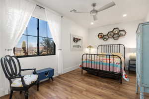 Bedroom with baseboards, visible vents, ceiling fan, wood finished floors, and recessed lighting