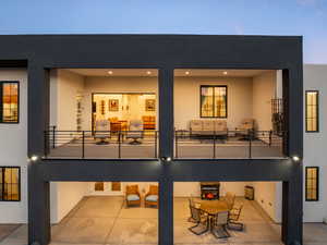 Back of house with a patio, an outdoor hangout area, a balcony, and stucco siding