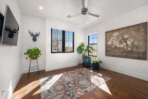 Living area with baseboards, visible vents, a ceiling fan, hardwood / wood-style flooring, and recessed lighting