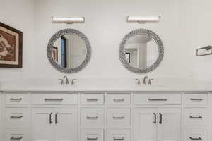 Bathroom featuring double vanity and a sink