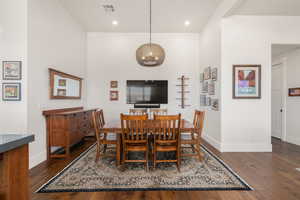 Dining room featuring visible vents, baseboards, and wood finished floors