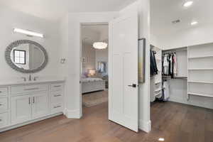 Ensuite bathroom with recessed lighting, wood finished floors, visible vents, and baseboards