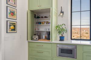 Interior space featuring light countertops, stainless steel oven, and green cabinets