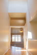 Corridor with baseboards and wood finished floors