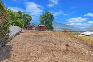 Unlandscaped part of the lot behind the back fence with mountain views