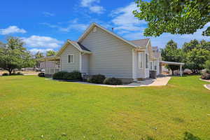 SIde of home with trees and grass area