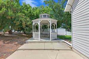 Side of home with extra parking and gazebo